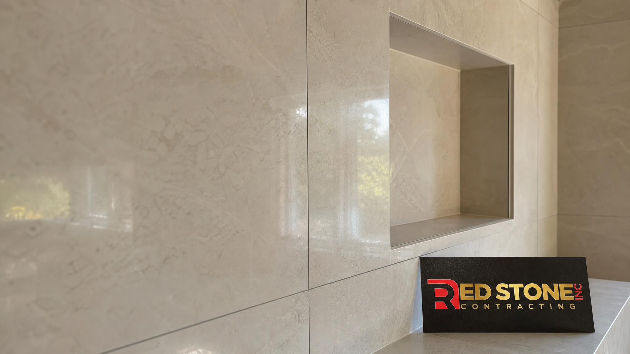 Close-up of large-format porcelain wall tile with a recessed shower niche and precise grout lines in a Mississauga bathroom