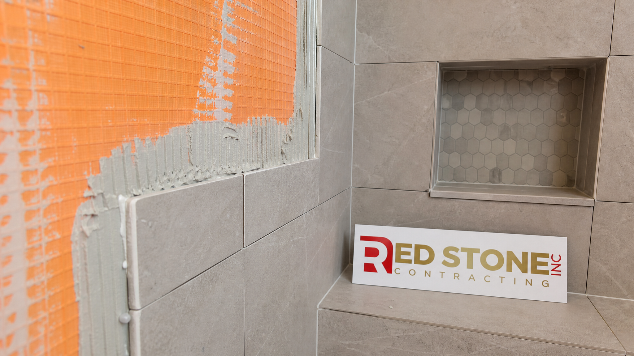 Close-up of waterproofing membrane and porcelain tile detail in a Milton bathroom shower installation