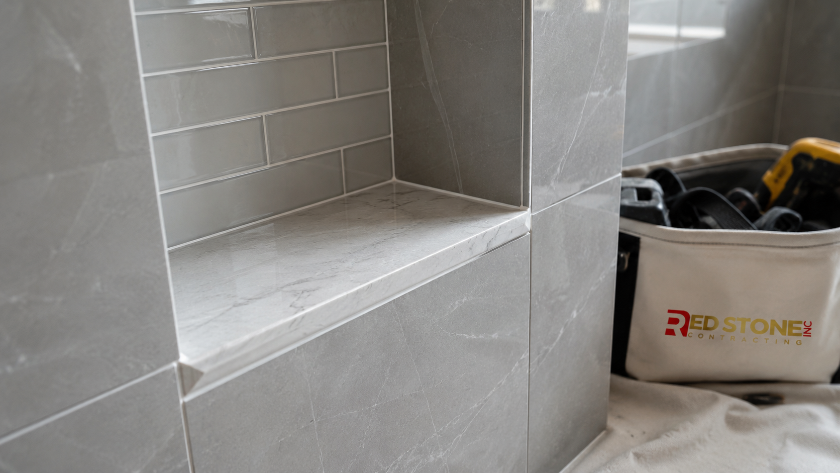 Close detail of tiled shower niche and grout lines from a completed bathroom renovation Etobicoke project