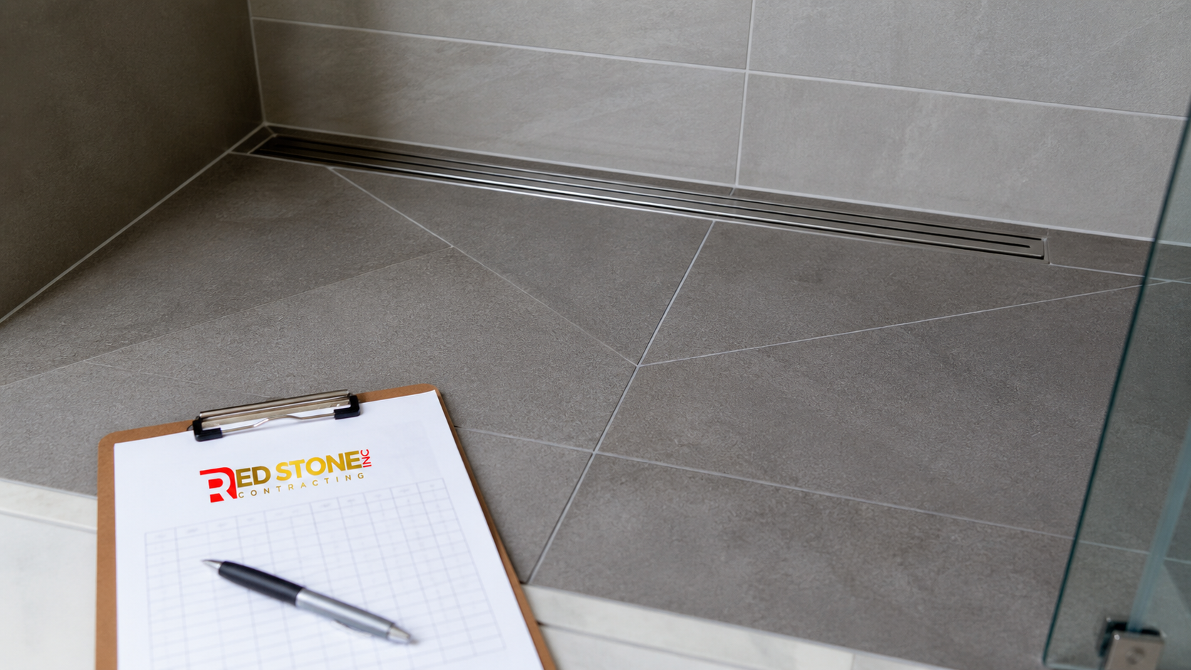 Detail of shower floor slope and linear drain from a finished bathroom renovation Scarborough project
